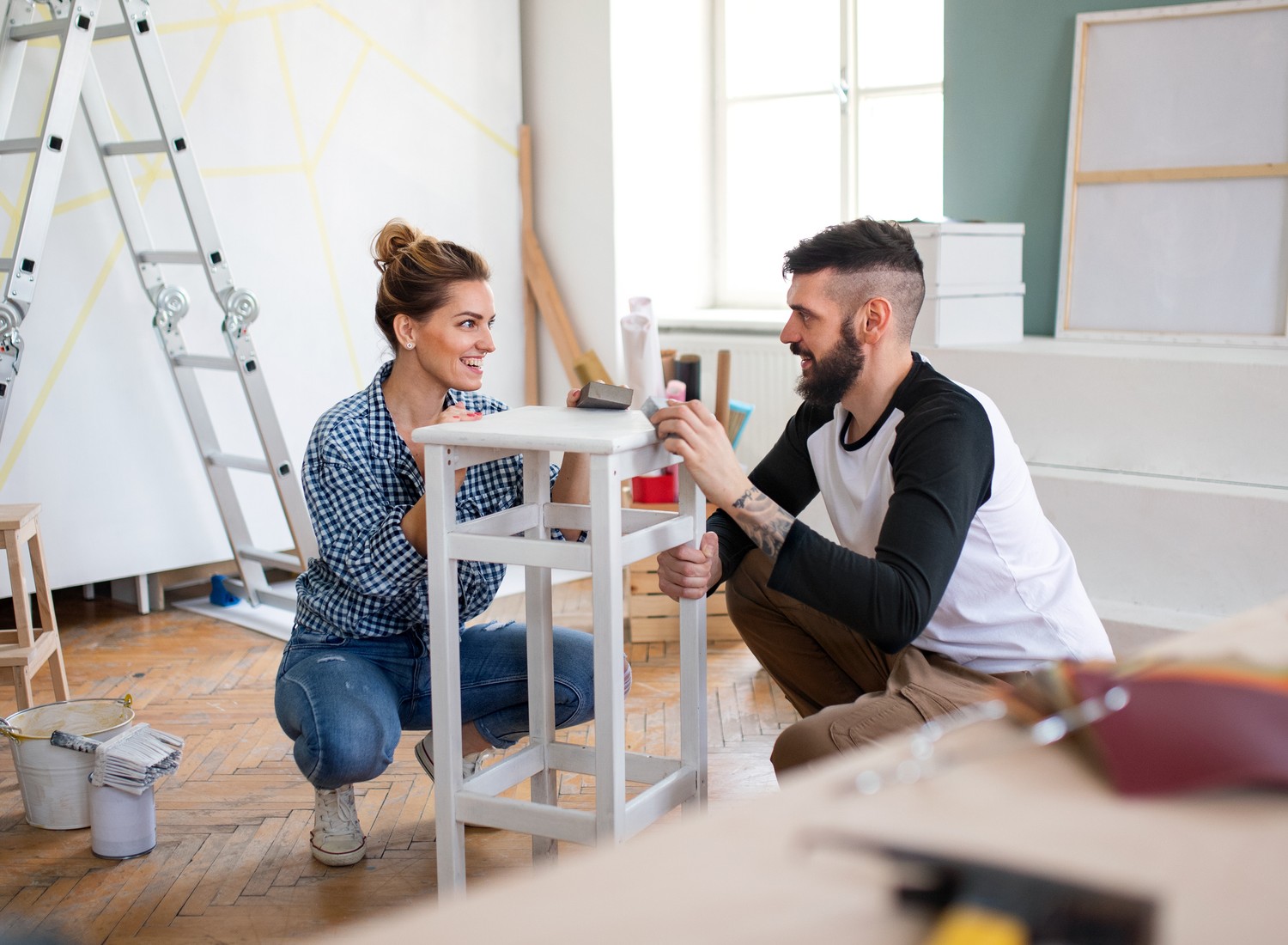 Happy mid adults couple renovating furniture indoors at home