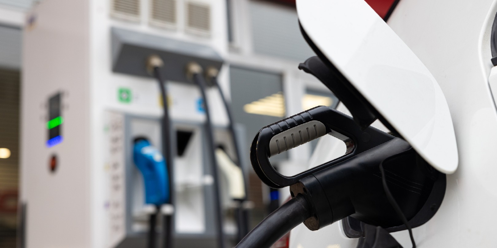 Close up of an electric car charging at the electric vehicle charging station