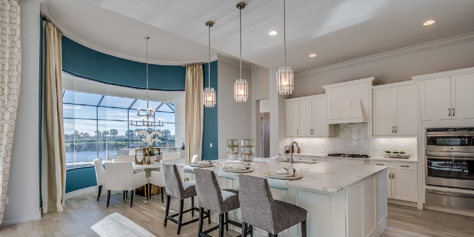 Amenities in new kitchen include double oven, wood floor and pendant lighting