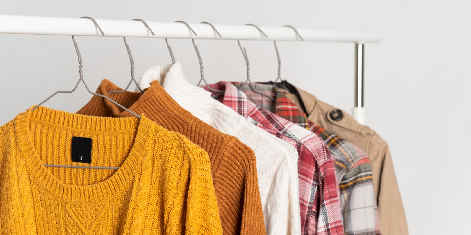 Autumn vintage clothing hangs on hangers on the rack