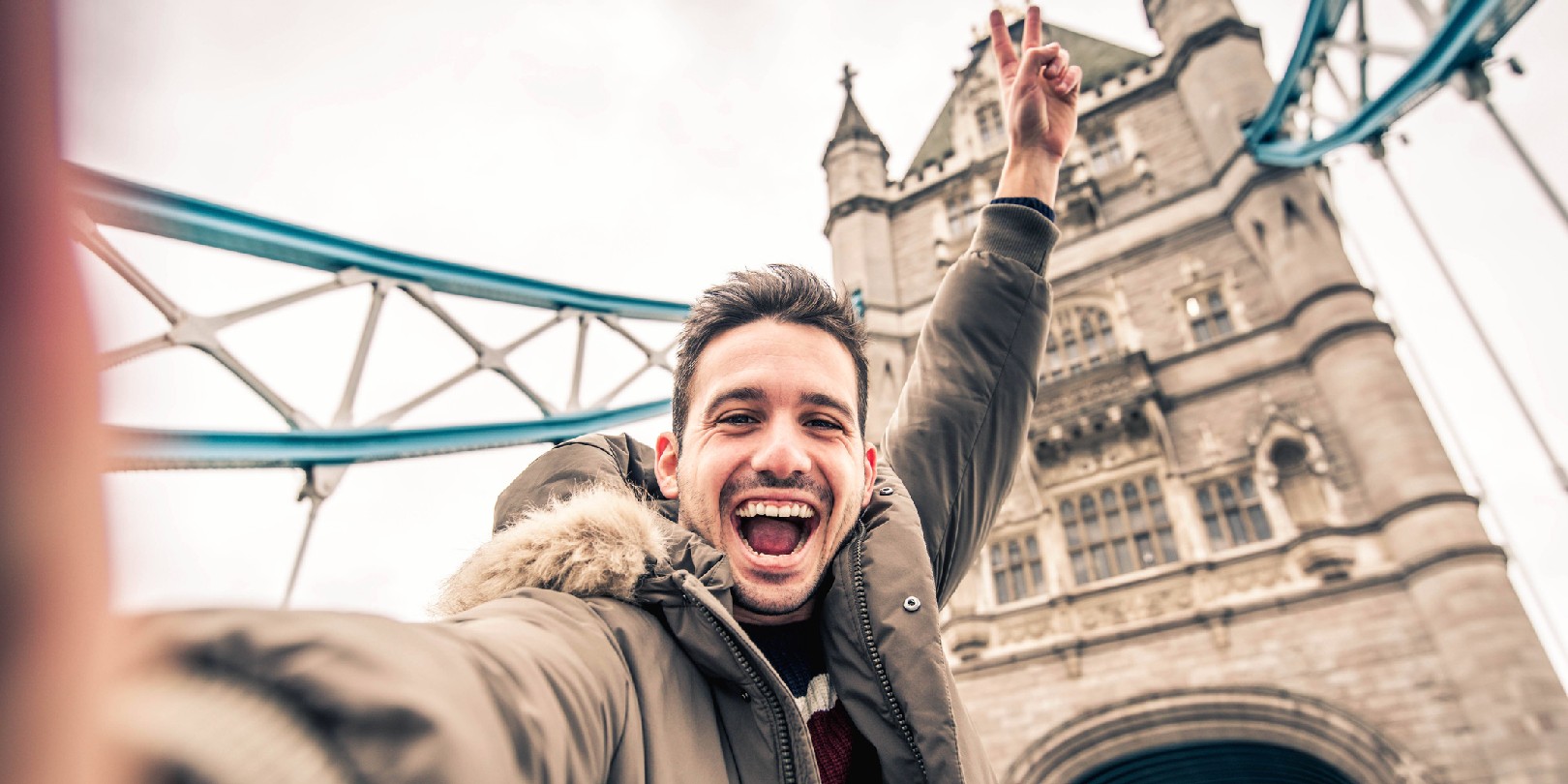 Smiling man taking selfie portrait during travel in London, England