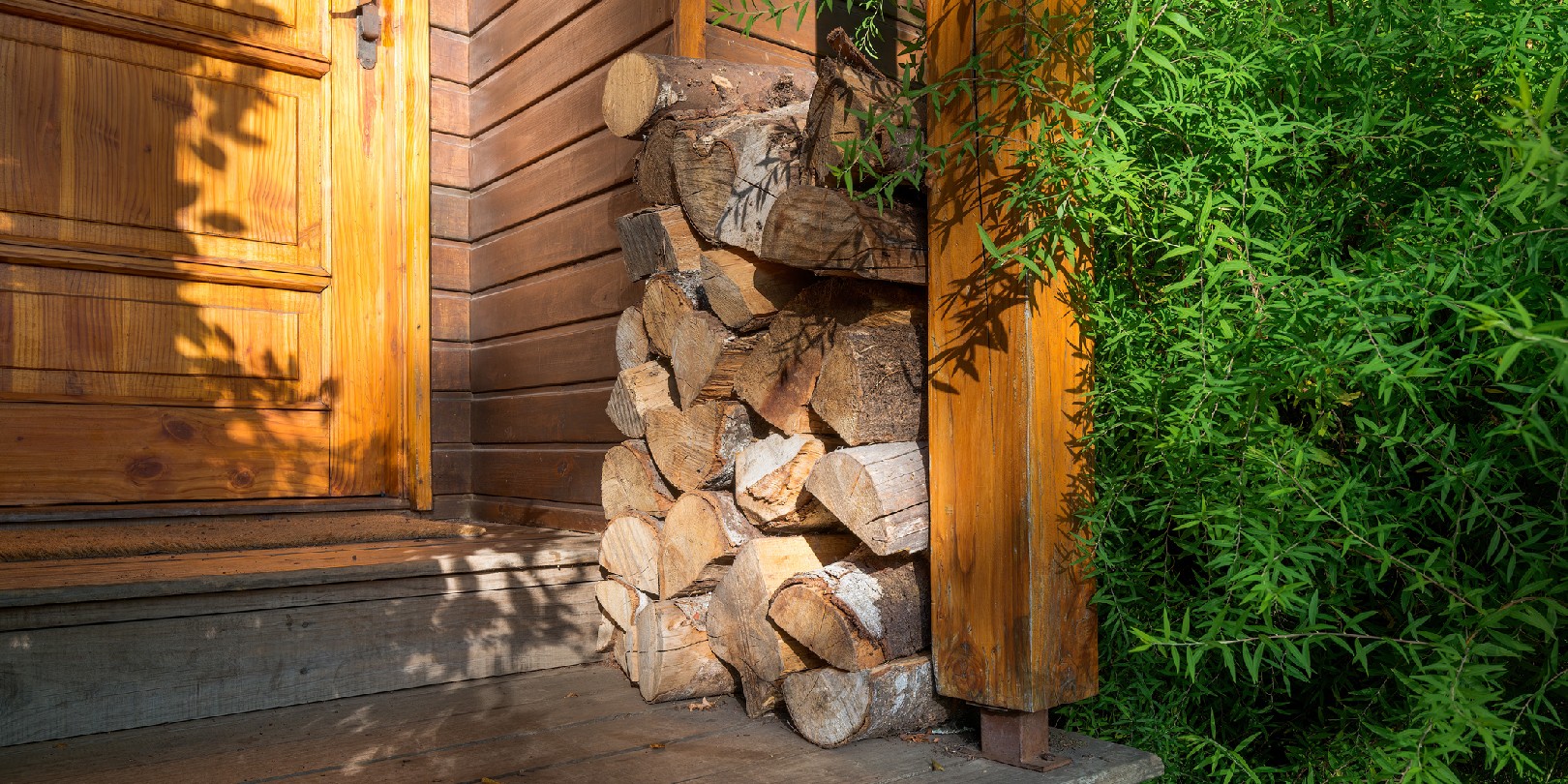 Stack of firewood outside a cabin.