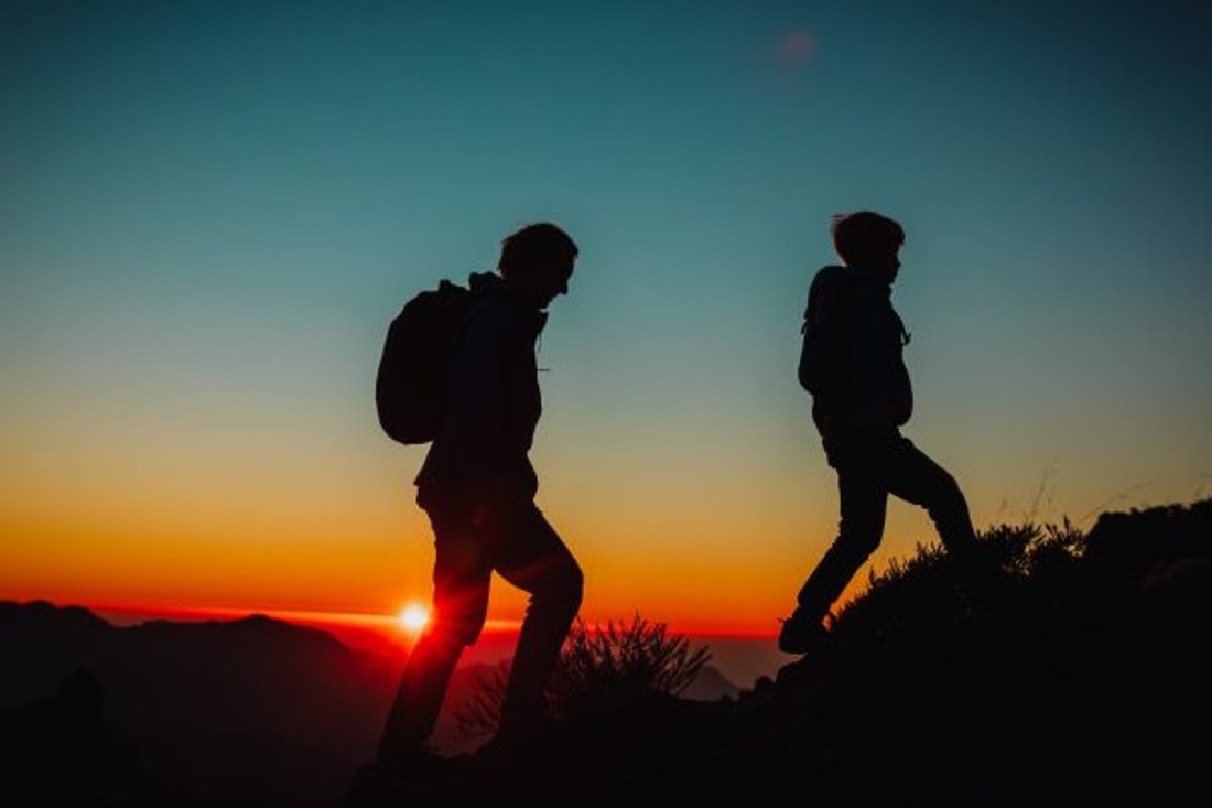 Father and son hiking at night